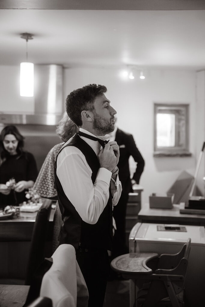 B&W image of groom getting ready at Barlow Woodseats Hall