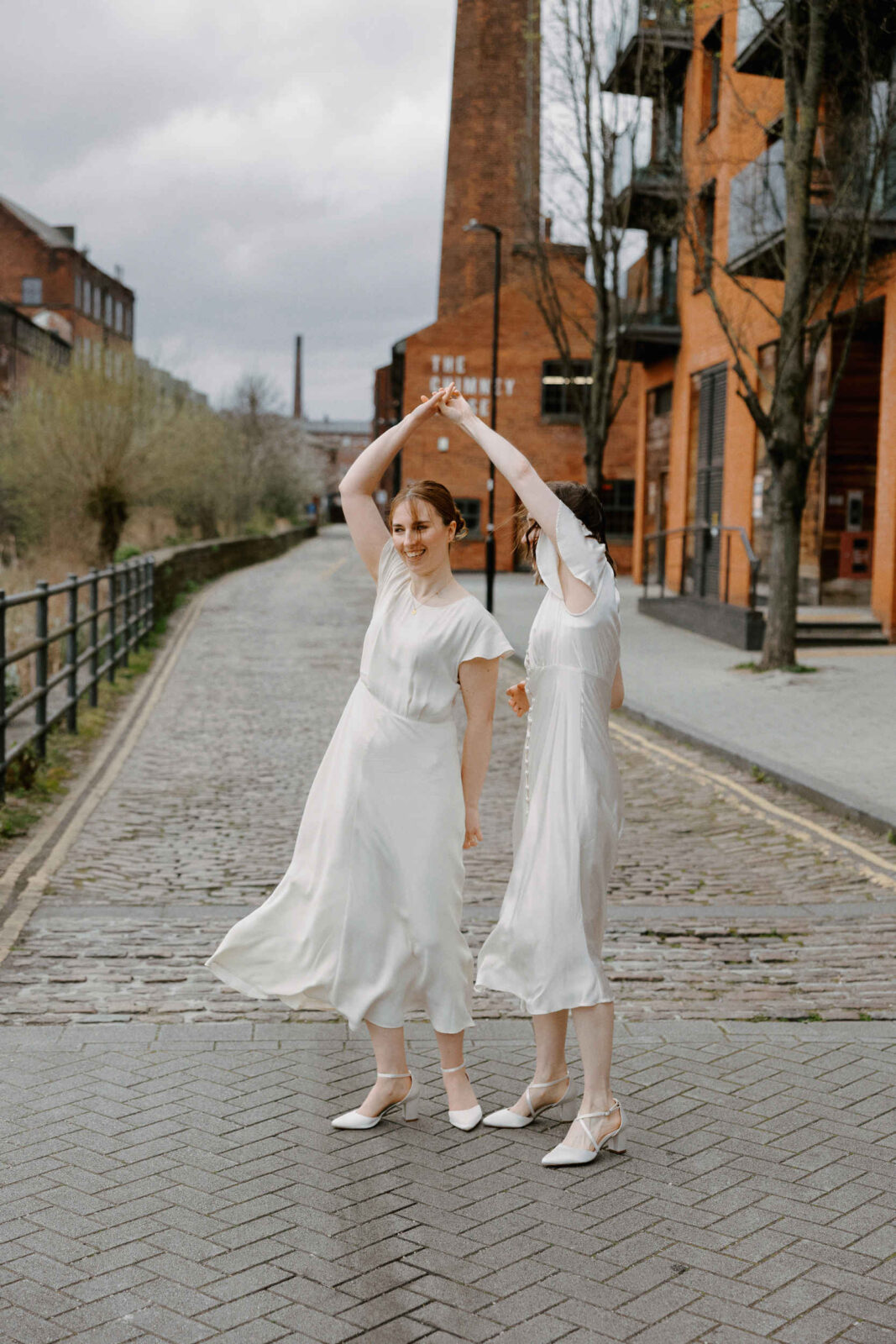 LGBTQ+ Same sex couple dancing in the street at The Chimney House Wedding venue 