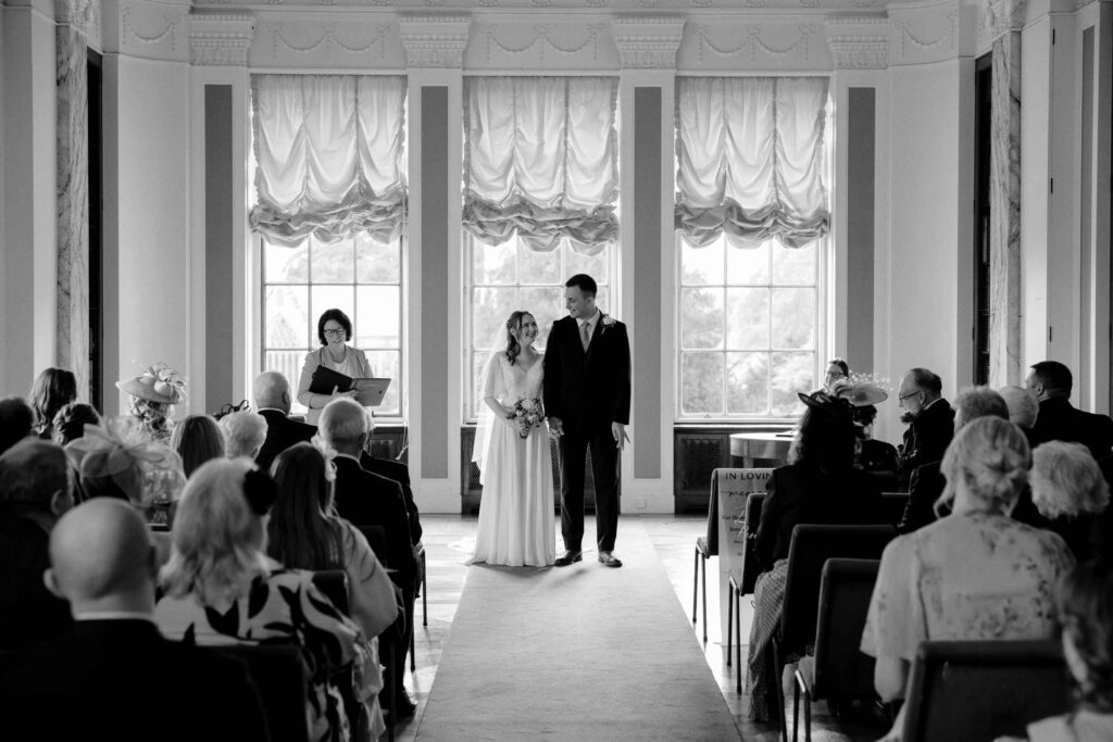 Bride and Groom at the aisle after their wedding ceremony inside Sledmere House in Driffield