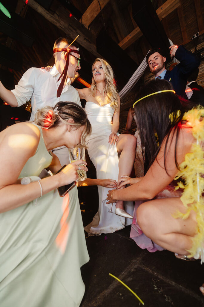 Bride taking off her shoes. Photography at Barlow Woodseats hall wedding