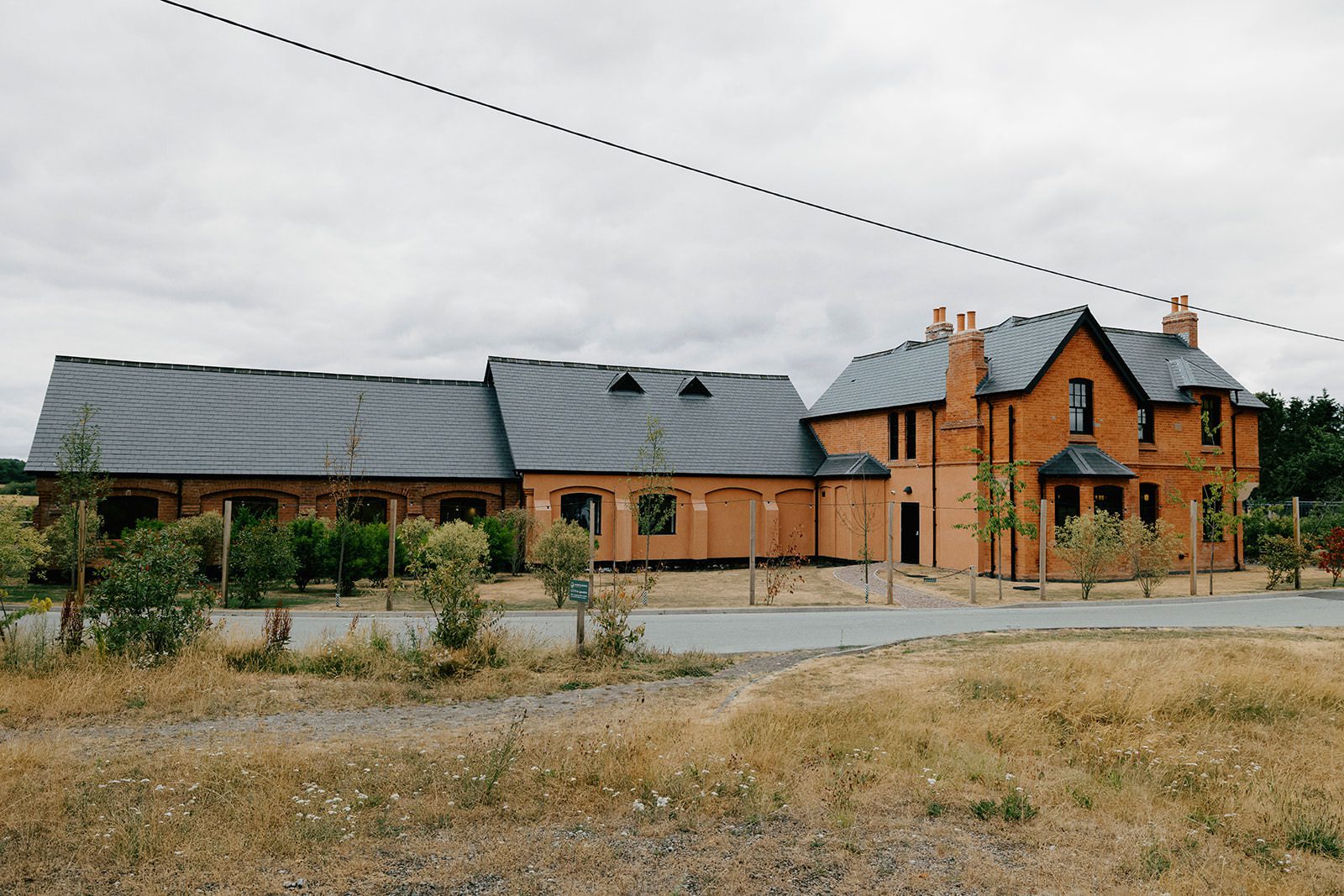 Wide view of the converted barns and red-brick house at Whistle Barns, Heanor